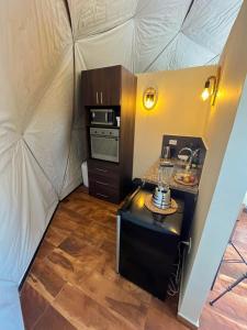 an interior view of a small kitchen in a tent at Sweet Forest-Domo Sol in Sanabria