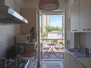 a kitchen with a view of a patio with a table at Suite and Home between Milano, Malpensa e Como Lake in Saronno