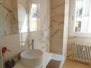 a bathroom with a sink and a toilet and a mirror at Suite and Home between Milano, Malpensa e Como Lake in Saronno +10 photos