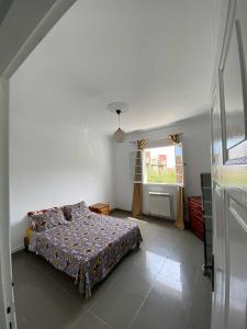 a bedroom with a bed and a window at Dany house in Aïn El Turk