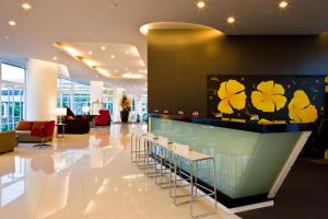 a lobby with a bar with stools at Hotel J Pattaya - SHA Extra Plus in Pattaya Central