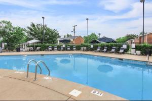 a large swimming pool at a hotel with chairs at Brentwood A2 I Cozy & Comfy I 2bd I Free Parking in Nashville