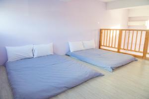 two beds sitting next to each other in a room at Country Lane in Checheng +15 photos