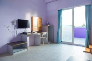 a room with a desk with a computer and a window at Country Lane in Checheng