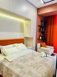 a bedroom with a large bed and a chair at Amber Nest Tsaghkadzor in Tsaghkadzor