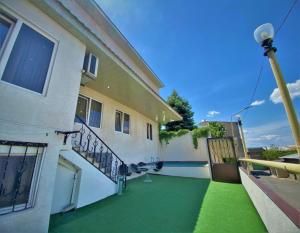 a balcony of a building with green grass at Lux Villa Yerevan in Yerevan