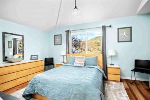 a bedroom with a bed and a large window at Ocean Oasis in Rockaway Beach