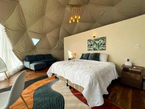 a bedroom with a large bed with a ceiling at Sweet Forest- Domo Luna in Punilla