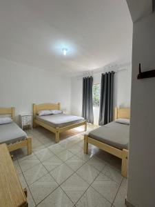 a room with two beds and a window at Chácara em Piracaia in Piracaia