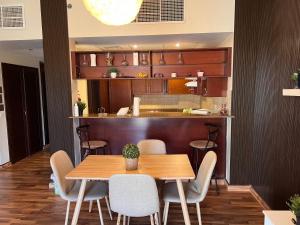 a dining room with a wooden table and chairs at مارينا موج البحر غرفتين اطلاله بحريه عوائل فقط Marina sea waves in King Abdullah Economic City