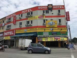 a car parked in front of a building at Soho Hotel Semenyih in Semenyih