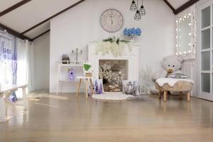 a living room with a teddy bear sitting in a chair at Апартаменти Studio Amur Creative in Khmelnytskyi