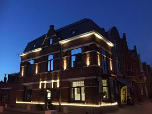 a building with lights on it at night at Maison du Rempart Guesthouse a 15-Min Walk from Bruges Centre in Bruges
