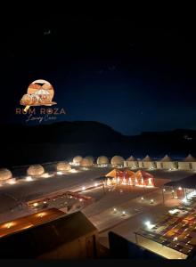 a night view of a building with lights in the dark at Rum ROZA Luxury Camp in Wadi Rum