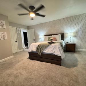 a bedroom with a bed with a ceiling fan at Raider Retreat-Your TTU Basecamp in Lubbock