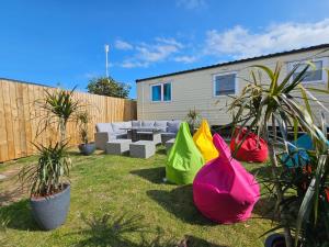 a backyard with colorful bags in the grass at Platinum Caravan with Decking & Garden in Abergele