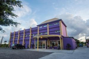 a purple building with a car parked in a parking lot at Country Lane in Checheng