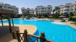 a swimming pool in front of some apartment buildings at Sharm Hills Luxury Pool View in Sharm El Sheikh