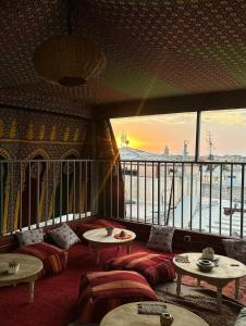 una stanza con divani e tavoli e una grande finestra di Oasis Medina Hostel a Marrakech