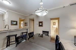 a dining room with a table and chairs at Hidden Dunes 1706 in Destin