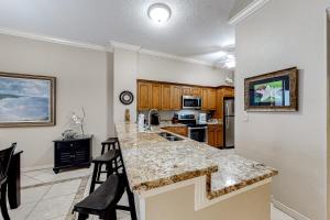 a kitchen with a large island in a room at Hidden Dunes 1706 in Destin