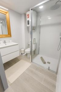 a bathroom with a shower and a toilet and a sink at Bravamar, Playa de Aro, vistas al mar in Platja d'Aro +37 photos