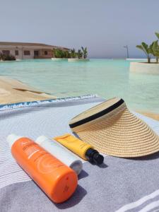 a straw hat and a swimming instrument next to a swimming pool at Résidence 7 vagues in Oualidia