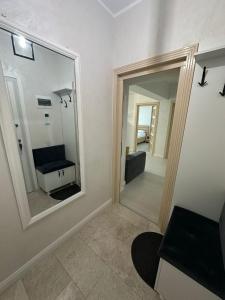 a living room with a mirror and a couch at Miaujour - perfect stay in Iaşi
