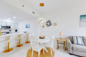 a kitchen and living room with a table and chairs at Luau II 6229 in Destin