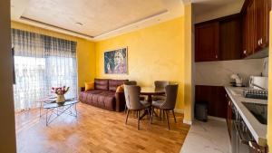 a living room with a couch and a table and chairs at Harmony Apartment 2 in Bar