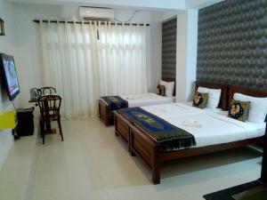 Postel nebo postele na pokoji v ubytování Kandy Supreme Hotel