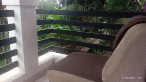 a chair sitting on a balcony with a view at Mannath Home in Alwaye