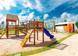 a park with a playground with a slide at Flat em muro alto in Ipojuca