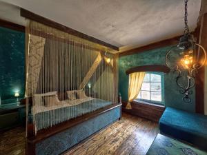 a bedroom with a bed in a room with a window at Cottage With Sauna, Pub & Terrace in Płóczki Górne