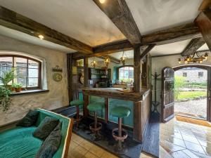 a room with a bed and a bar in a house at Cottage With Sauna, Pub & Terrace in Płóczki Górne +26 photos