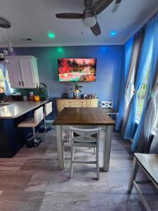 a kitchen with a wooden table and a blue wall at Boro Breeze Vacation Rental in Murfreesboro