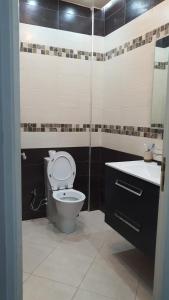 a bathroom with a toilet and a sink at Villa entière in Azemmour +10 photos