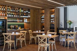 a restaurant with wooden walls and tables and chairs at Quinta da Amendoeira - Évora - The Farmhouse in Évora