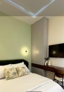 a bedroom with a bed and a desk and a tv at Eko Luxury Apartments in Ikeja