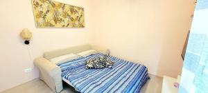 a small bedroom with a bed with a blue blanket at Lavagna - Chiavari modern apartment - vicino mare in Lavagna