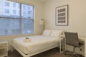 a bedroom with a bed and a desk and a window at Boulevard Stays Modern Tempe 1BR ASU Pool Gym 13 in Tempe