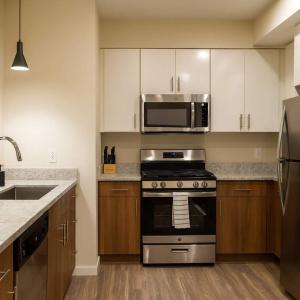 a kitchen with a stove and a microwave at Boulevard Stays Modern Tempe 1BR ASU Pool Gym 14 in Tempe