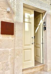 a white door on the side of a building at Terratetto - Apulia in Ceglie Messapica