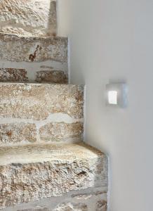 a brick wall with a lightswitch on a wall at Terratetto - Apulia in Ceglie Messapica