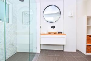 a bathroom with a sink and a mirror at Boat Harbour Beach House in Boat Harbour +34 photos