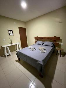 a bedroom with a bed and a desk in it at Casa Naurú in Fortim +26 photos