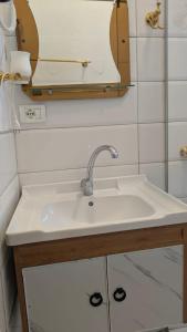 a bathroom with a sink and a mirror at Vila Kastriotet-Hotel in Lezhë +89 photos