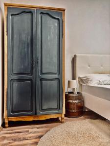 a bedroom with a bed and a black door at Villa Srna Apartments 