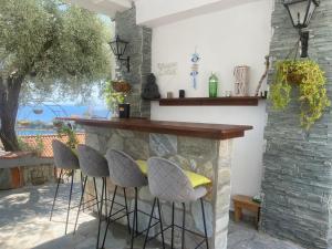 a bar in a patio with stools at Villa Seaside View Complex with pool in Volos