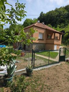 a house with a fence in front of it at Premecki konak in Čačak +5 photos